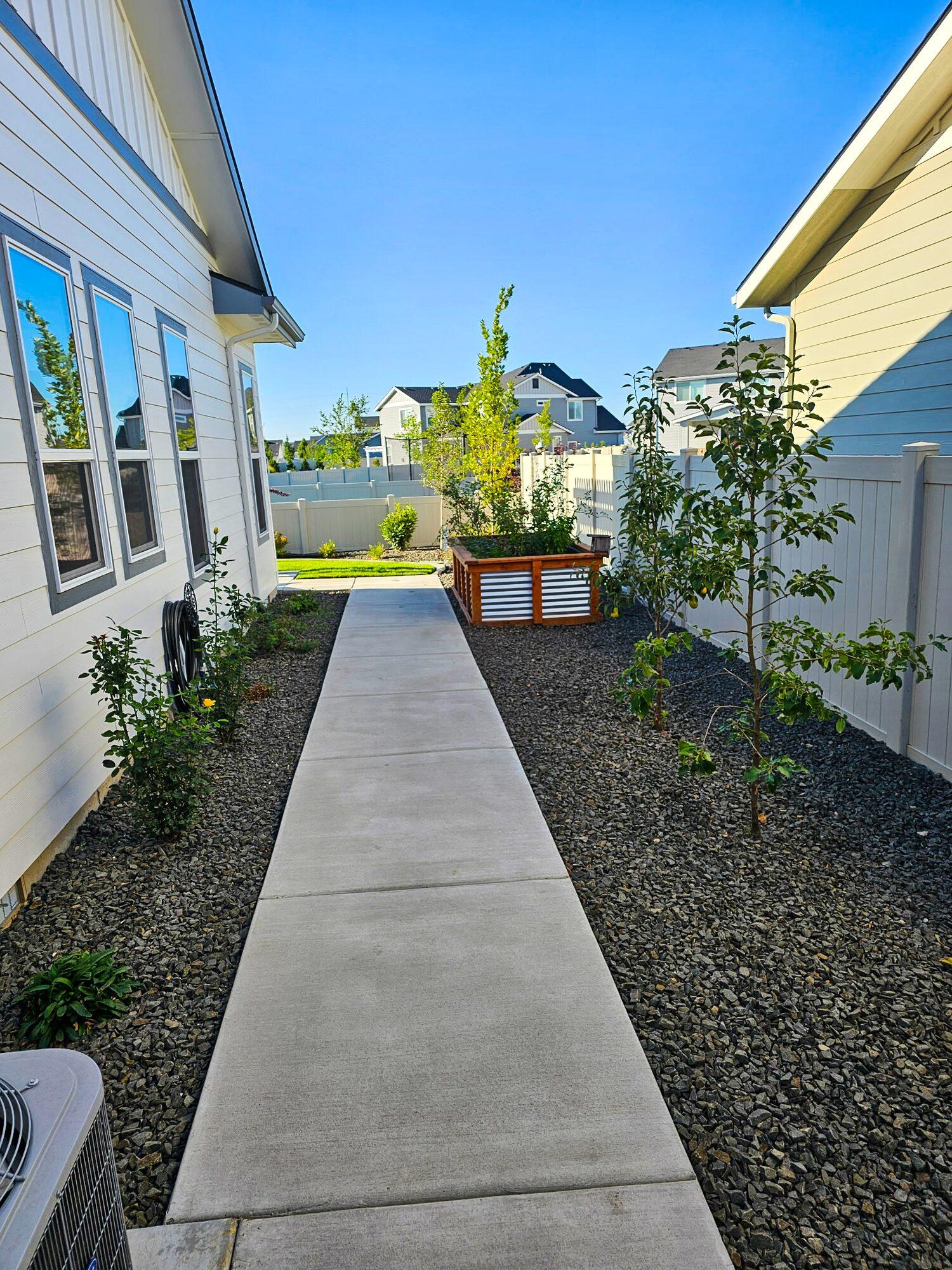 Concrete walkway beside a garden box