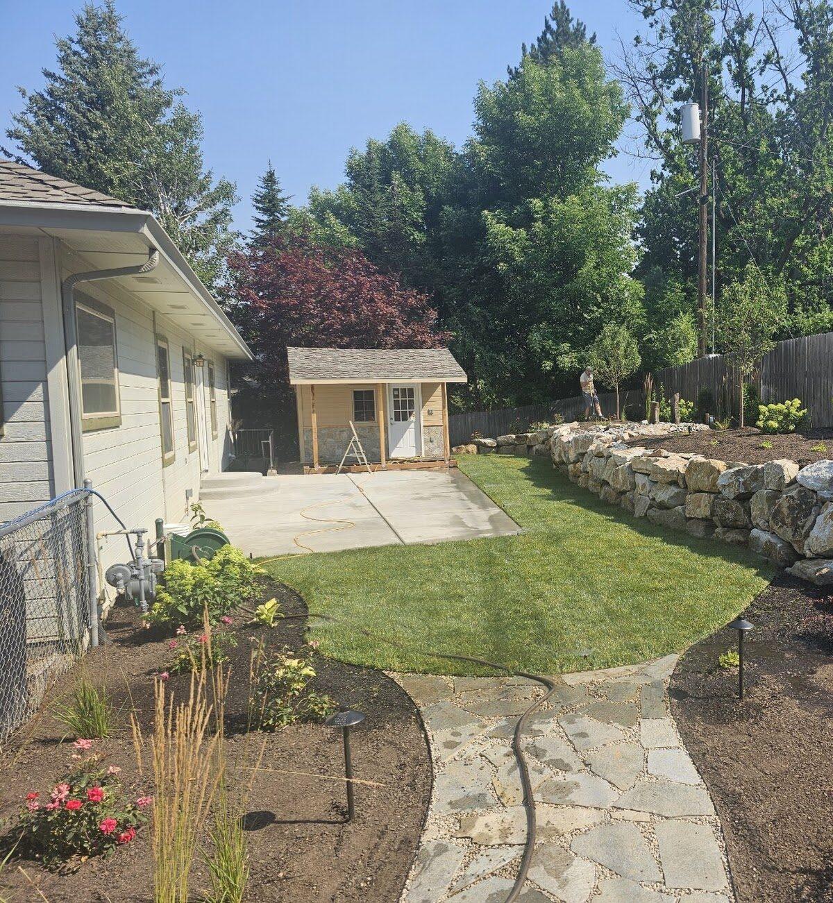Expansive landscape project featuring a grand rock wall and lush gardens