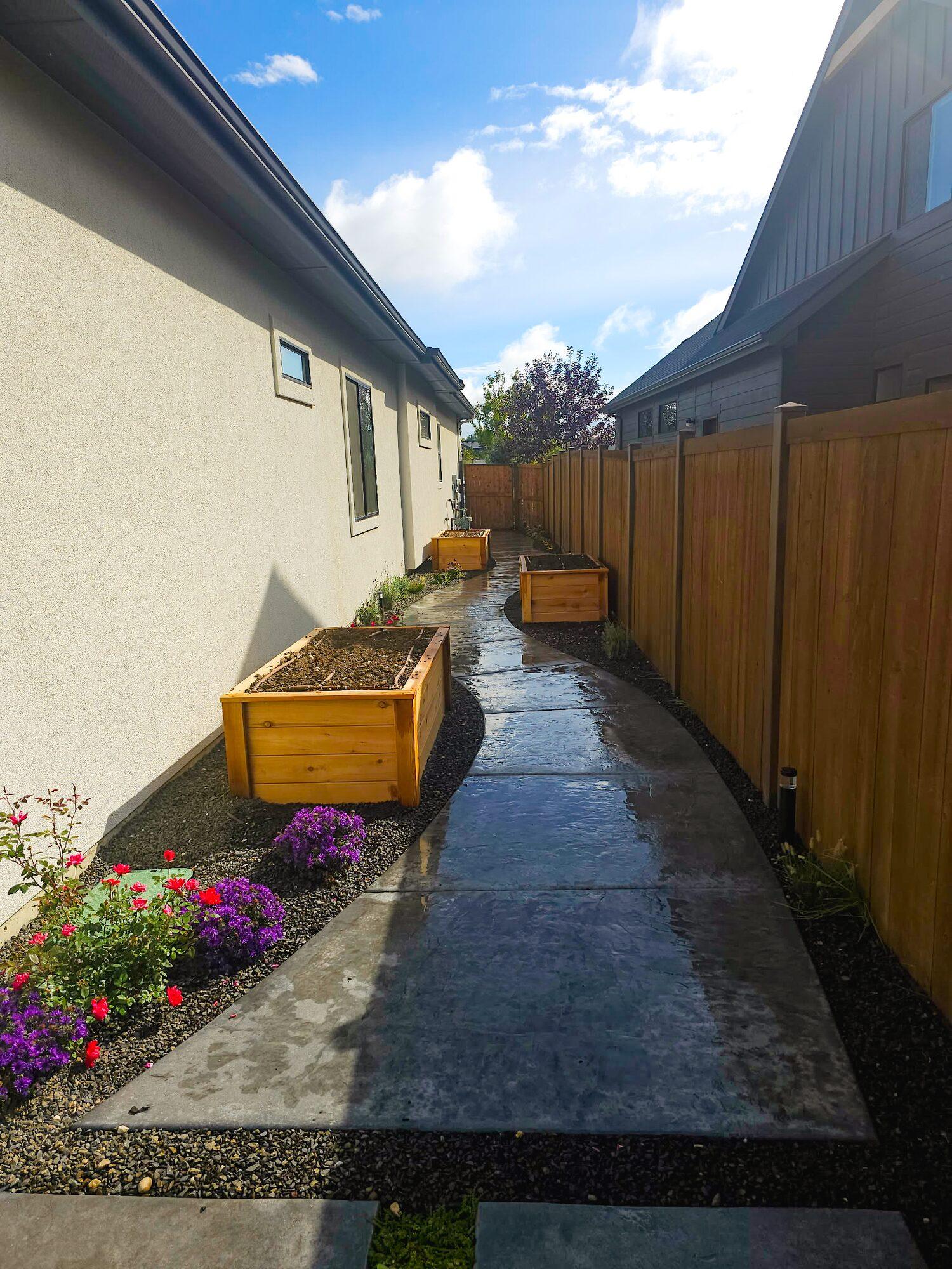 Stamped concrete walkway with garden boxes